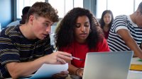 High school students working together on a computer