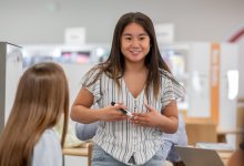 teenager presenting to a small group of people