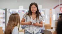 teenager presenting to a small group of people