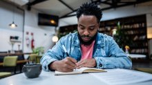 Adult writing in a notebook