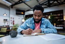Adult writing in a notebook