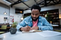 Adult writing in a notebook
