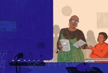 Chanea Bond hands out notebooks to students while the computer sits unused in the foreground