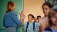 Teacher welcoming student with a high five