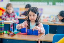 Kindergartner using magnetic toys in class