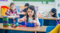 Kindergartner using magnetic toys in class
