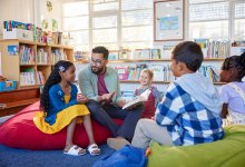 Teacher reading to students while sitting on beanbag chairs