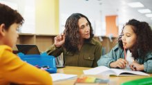 Teacher working with two students