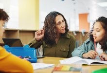 Teacher working with two students