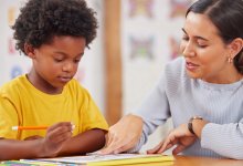 Elementary teacher working one-on-one with student