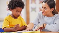 Elementary teacher working one-on-one with student