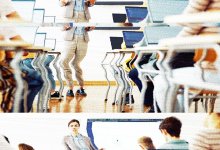 glitchy image of a teacher teaching to a classroom full of students on their laptops