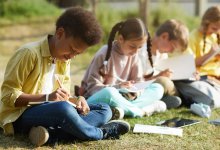 Elementary students writing outside