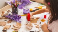 Elementary student working with found objects, representing playful learning in the early grades