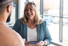 Woman smiling and talking to colleague
