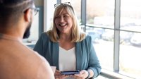Woman smiling and talking to colleague
