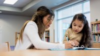 Elementary teach working with student