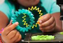 Student holding 3D-printed objects