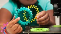 Student holding 3D-printed objects