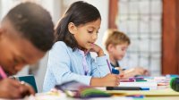 Elementary students writing in class