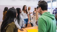 Small group of high school students talking in class