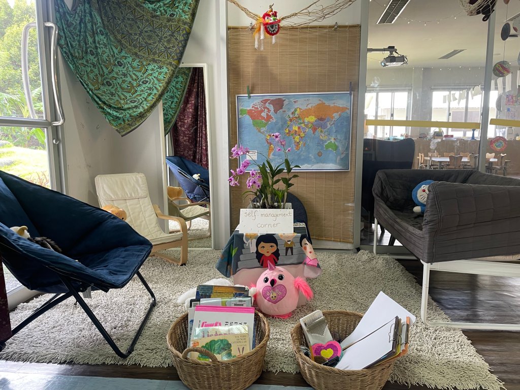 A photo provided by the author of a self-management corner (comfortable chairs, baskets of books and art supplies, and plushies).