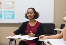 A photo of a high school student talking during a class discussion.