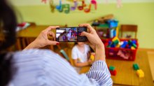 Elementary teacher making video of student