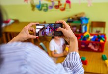 Elementary teacher making video of student