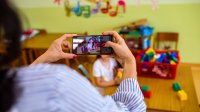 Elementary teacher making video of student