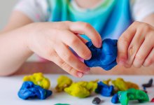 Child playing with colorful clay
