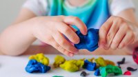Child playing with colorful clay