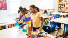 Elementary students building towers with magnetic tiles