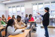Teacher talking at the front of the classroom