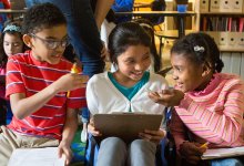 Elementary students working together on a math assignment