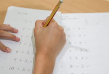 Elementary student completing math worksheet