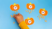 Child sorting pumpkin seeds by number