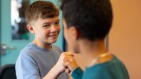 Two young children giving each other a fist bump