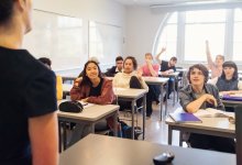 A photo of a middle school teacher lecturing to an engaged classroom.