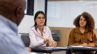 A photo of a group of administrators sitting in a circle and engaging in a discussion.