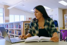 High school student studying in a library