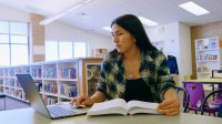 High school student studying in a library