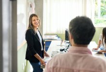 Teacher welcoming other teacher into her classroom