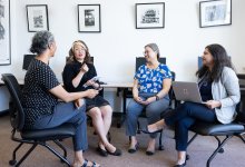 Coworkers in a small group meeting Leading a School Improvement Process