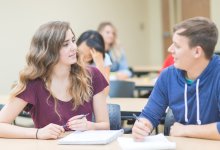 Two high school students discuss an assignment