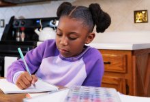 Elementary student doing homework at the kitchen table