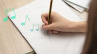 Student drawing slope graph with music notes