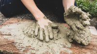 Child's hands playing in mud
