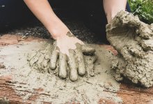 Child's hands playing in mud