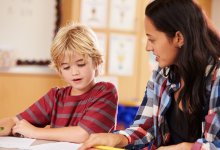 Teacher and student reviewing school work